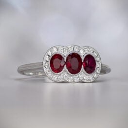 Three stone ring features oval cut rubies in platinum mounting Artistic Picture 13464