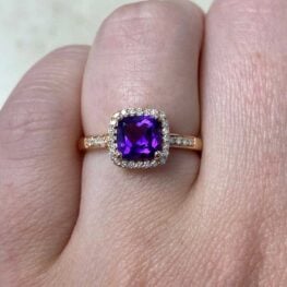 meridien engagement ring showcasing an amethyst surrounded by a halo of diamonds