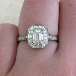 tillson engagement ring centering a bezel set emerald cut diamond