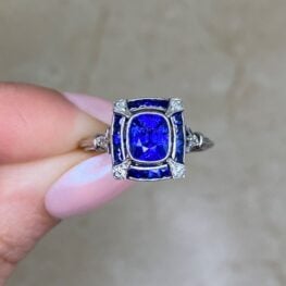 Sorrento Ring featuring a halo of French-cut sapphires surrounding the center
